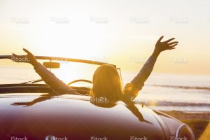 stock-photo-78080269-woman-watching-the-sunset-in-a-convertible-car-